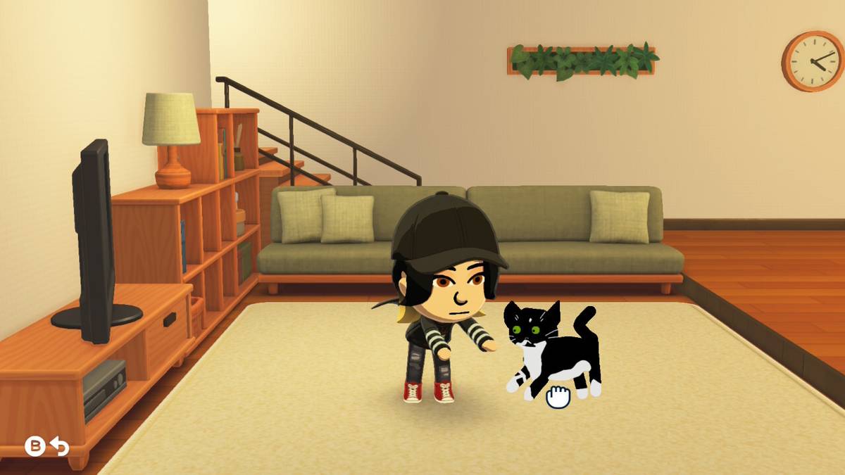 A Mii reaches for a cat in Tomodachi Life: Living the Dream.