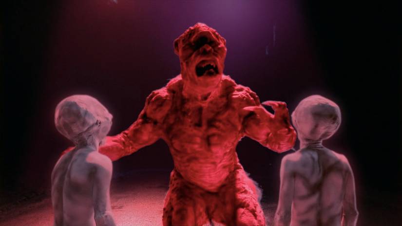 Two grey aliens face of againsyt cyclops alien