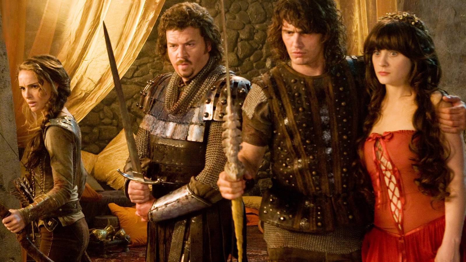 Natalie Portman, Danny McBride, and James Franco brandish weapons in medieval fantasy attire as Zooey Deschanel stands by.