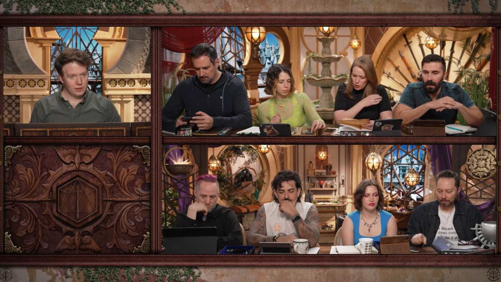 An image of Brennan Lee Mulligan as well as several members of the Critical Role cast sitting together around a table.