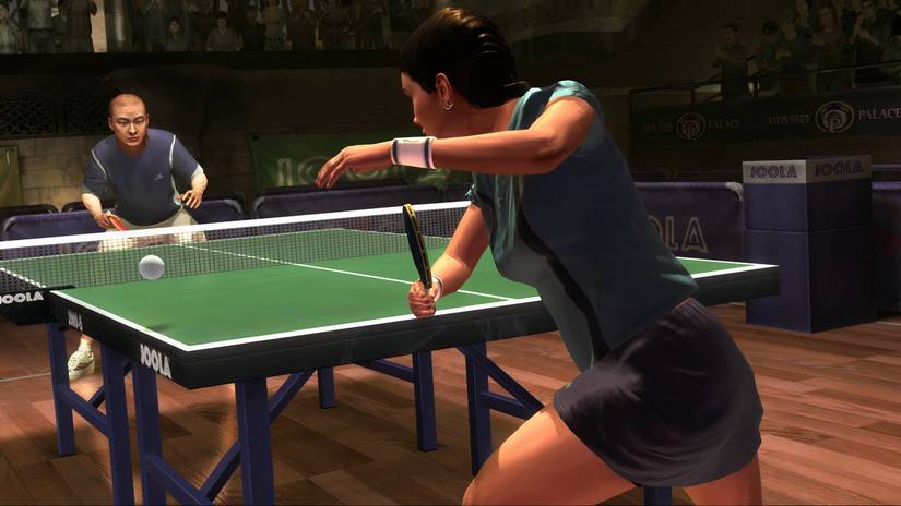 A woman and a man playing table tennis
