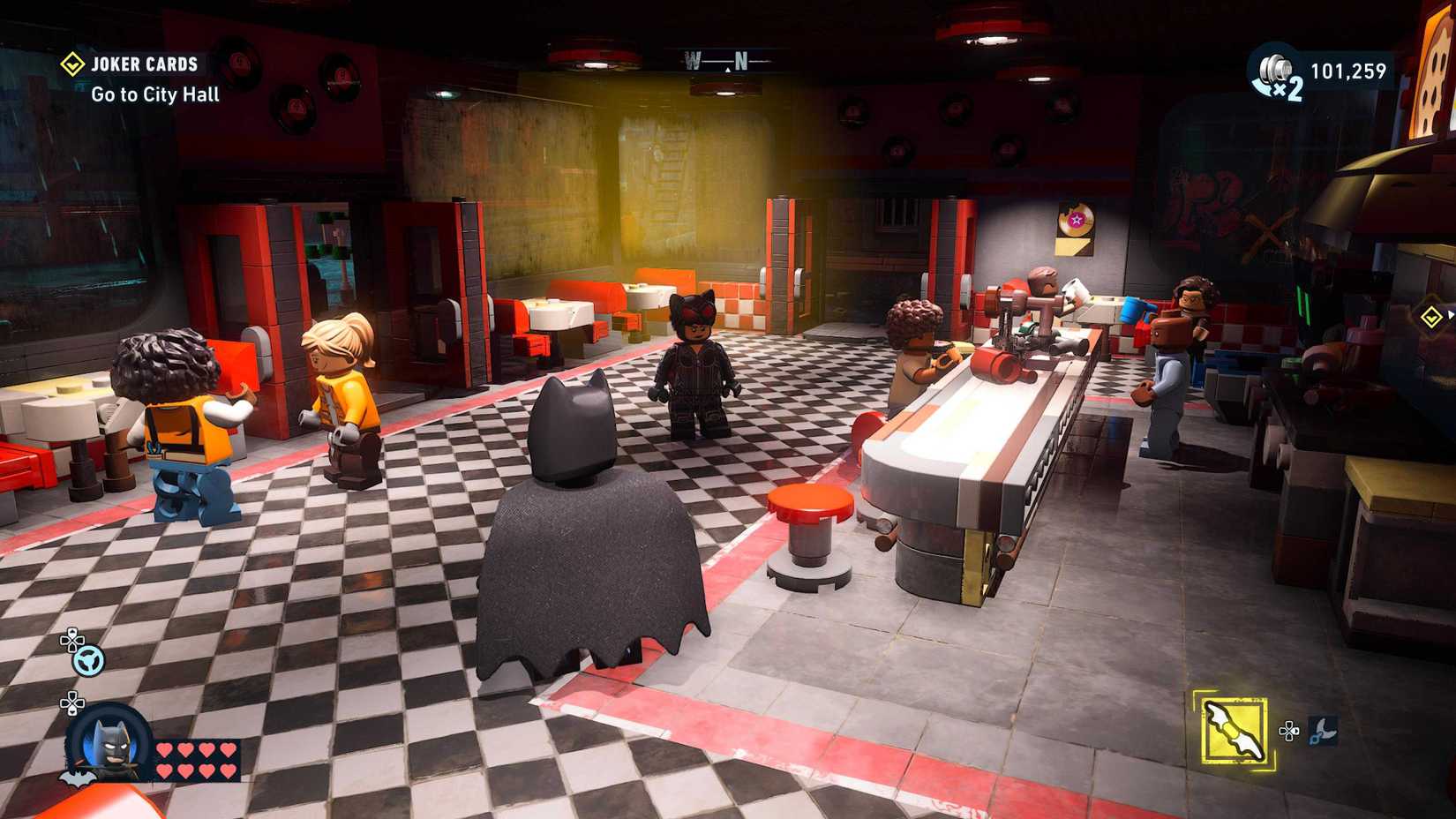 Lego Batman Legacy of the Dark Knight screenshot showing Batman and patrons in a diner