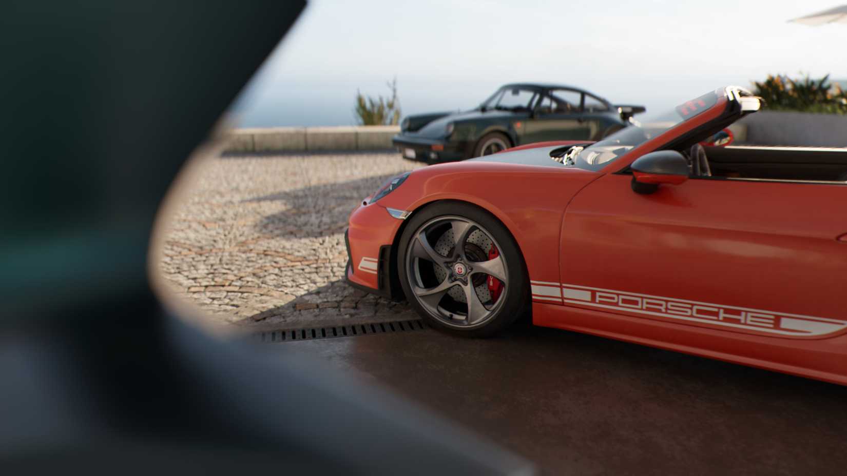 Two Porsche cars in a sunny Mediterranean location