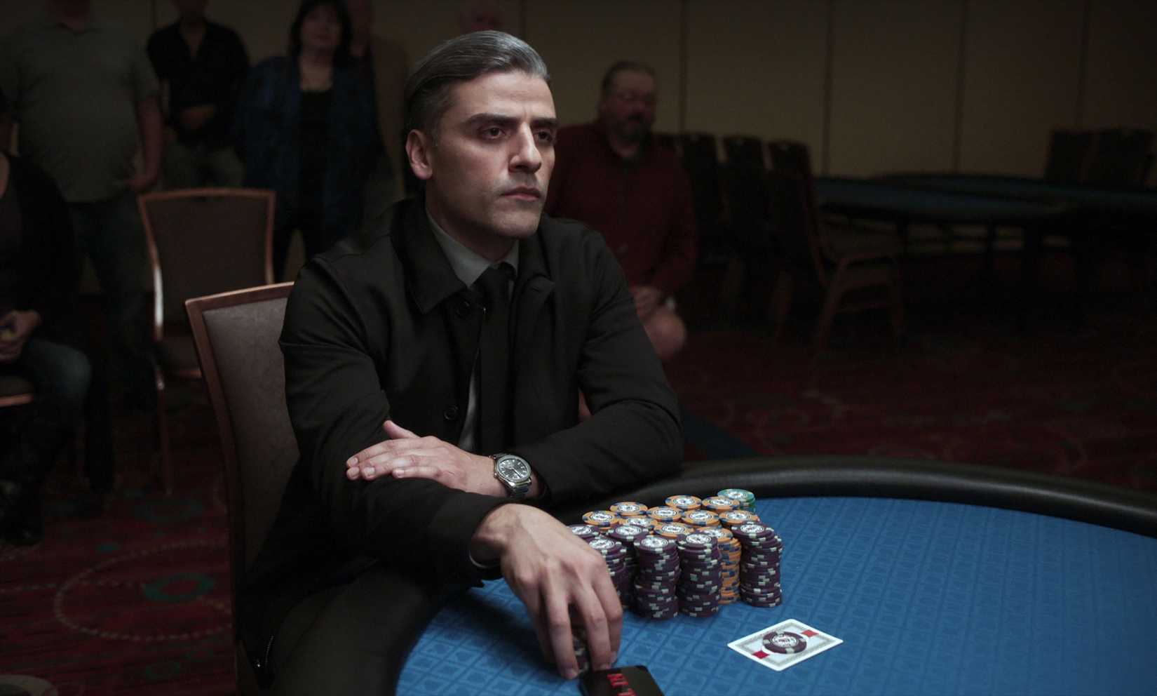 Oscar Isaac in The Card Counter holding his chips at the poker table