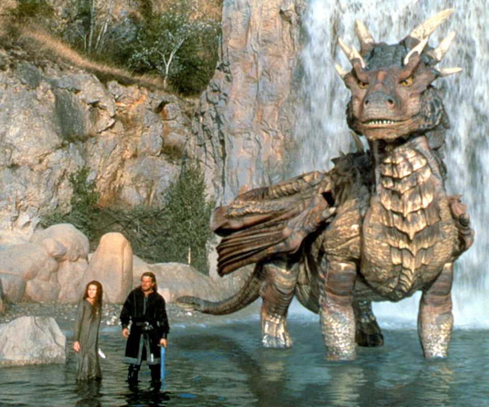 An image from Dragonheart 1996. It shows a woman and a man standing ankle deep in water. Next to them is a large dragon.