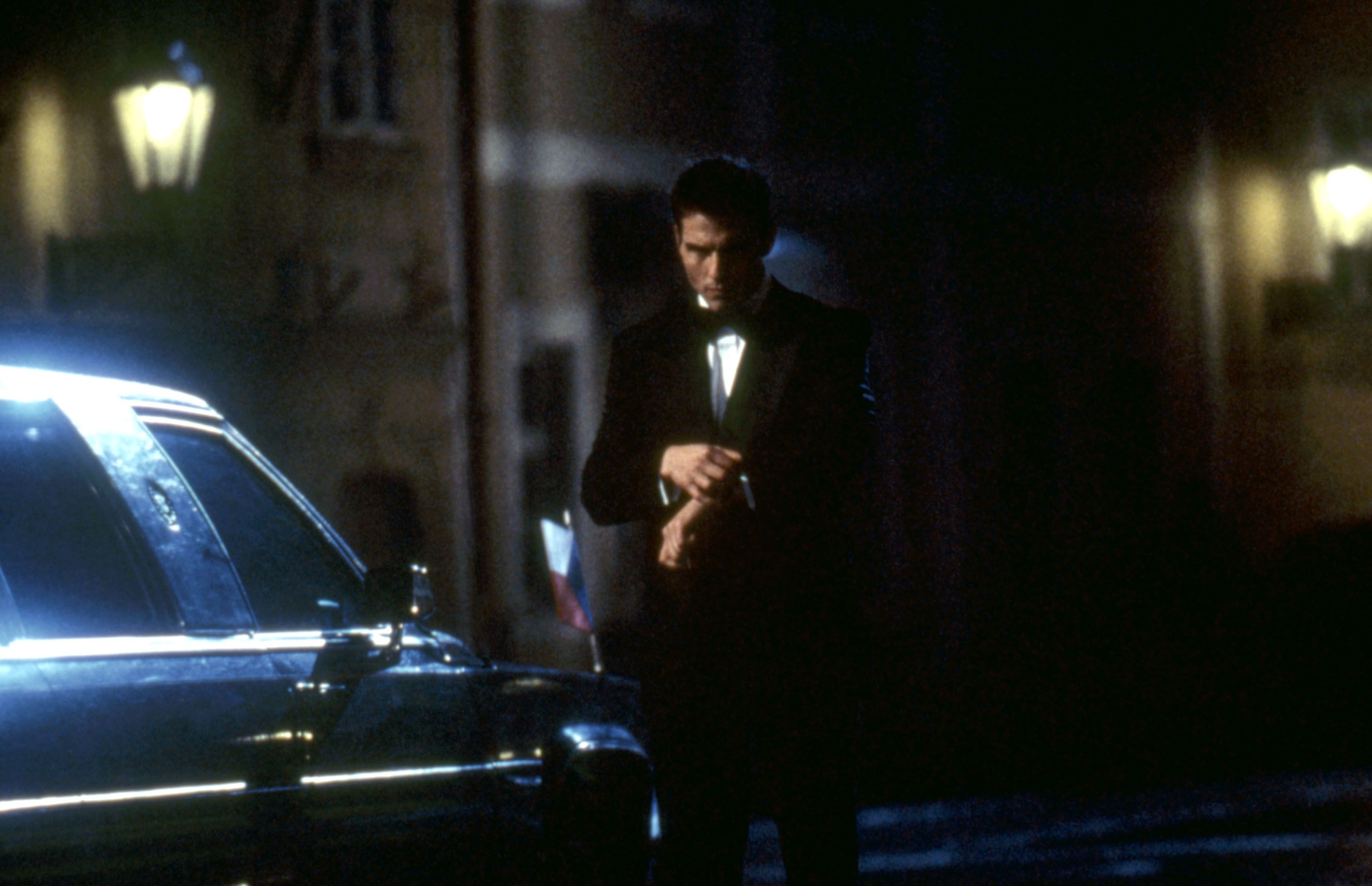 Tom Cruise in a dinner jacket checking his watch