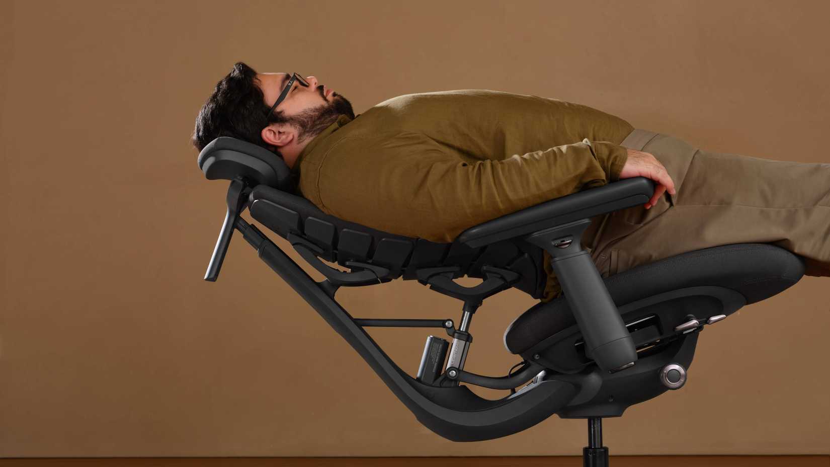 model lying back in a libernovo office chair.