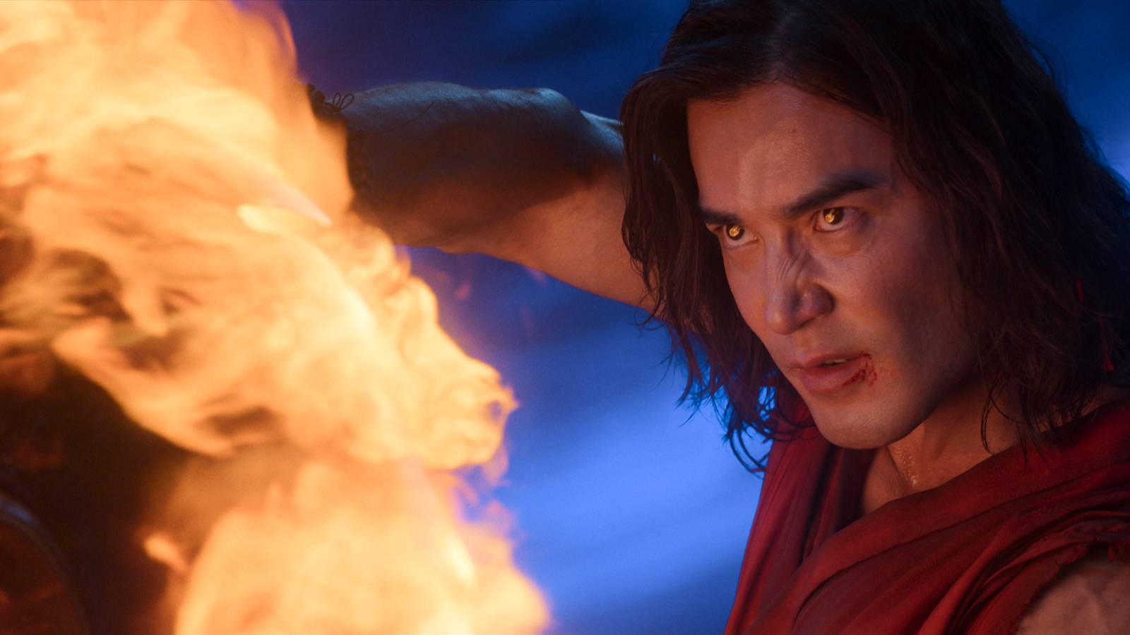 Liu Kang (Ludi Lin, a long-haired man in a red robe, looks ferocious as he blasts fire in Mortal Kombat 2