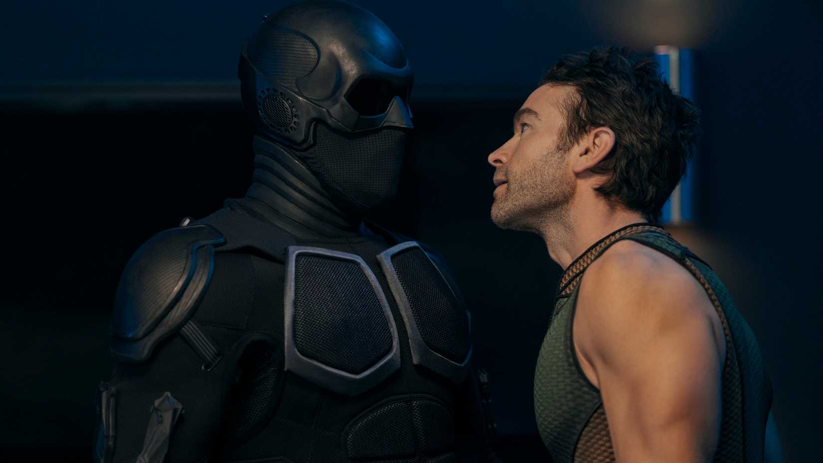 The Deep (Chace Crawford) stands close to Black Noir (Nathan Mitchell) looking up at him as they argue in The Boys.