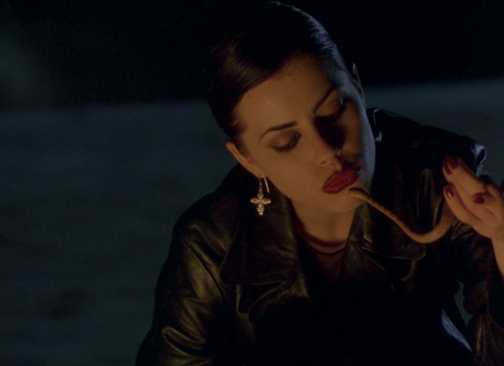 A teen girl in a leather jacket plays with a snake in The Craft 1996