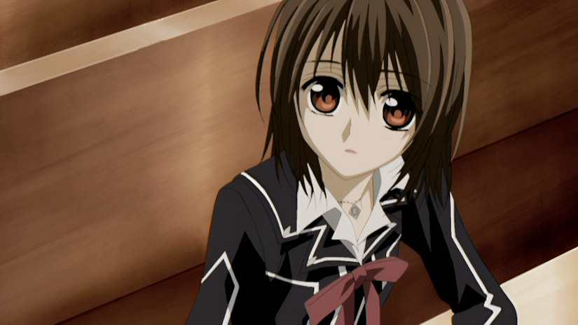 A young girl with brown hair sits at the bench of the academy in Vampire Knight