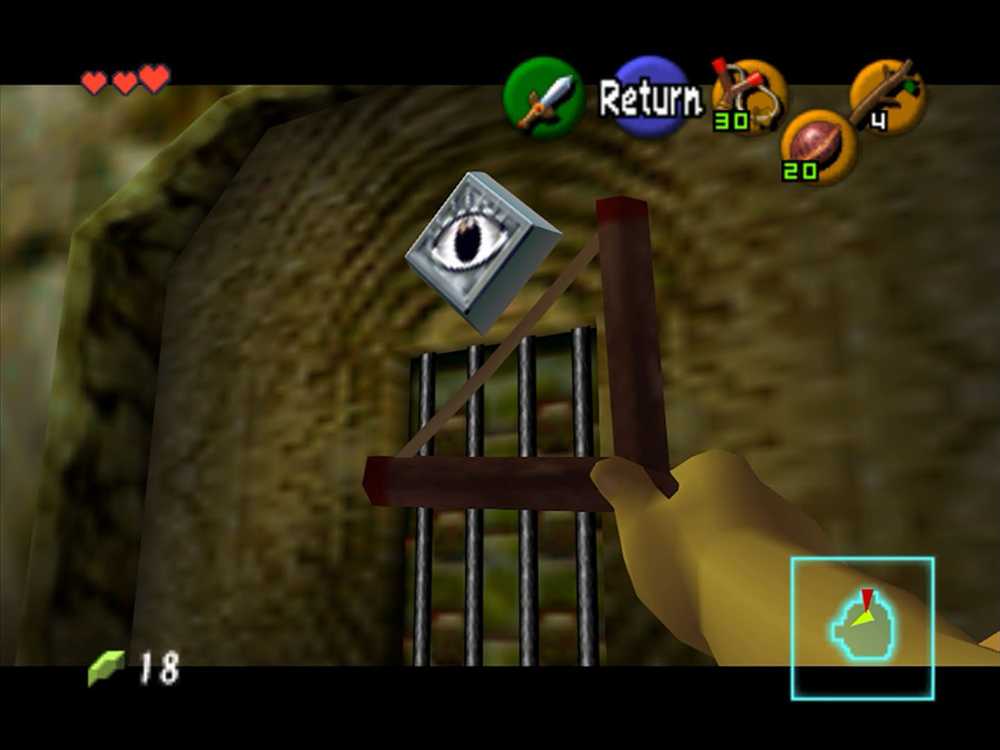 Uma m&atilde;o com estilingue apontado para um olho na parede em Ocarina of Time.