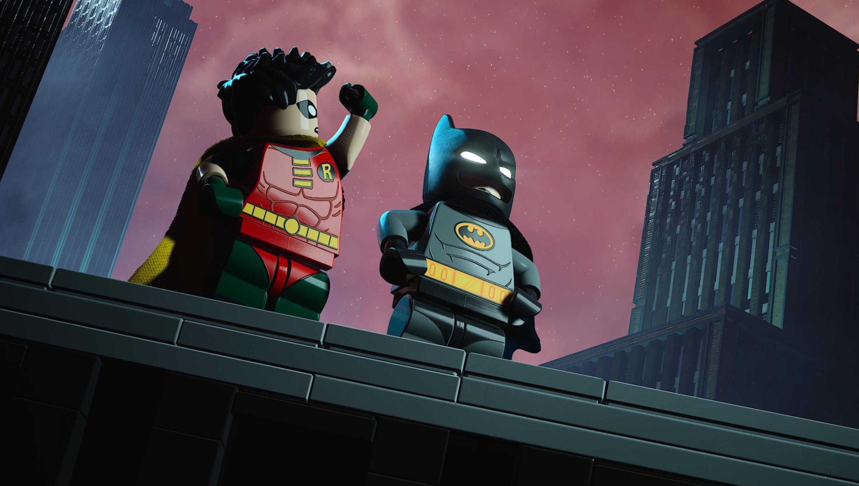 Lego Batman Legacy of the Dark Knight Batman and Robin standing on a rooftop in a parody of BTAS opening