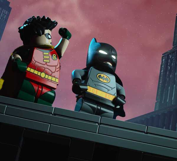 Lego Batman Legacy of the Dark Knight Batman and Robin standing on a rooftop in a parody of BTAS opening