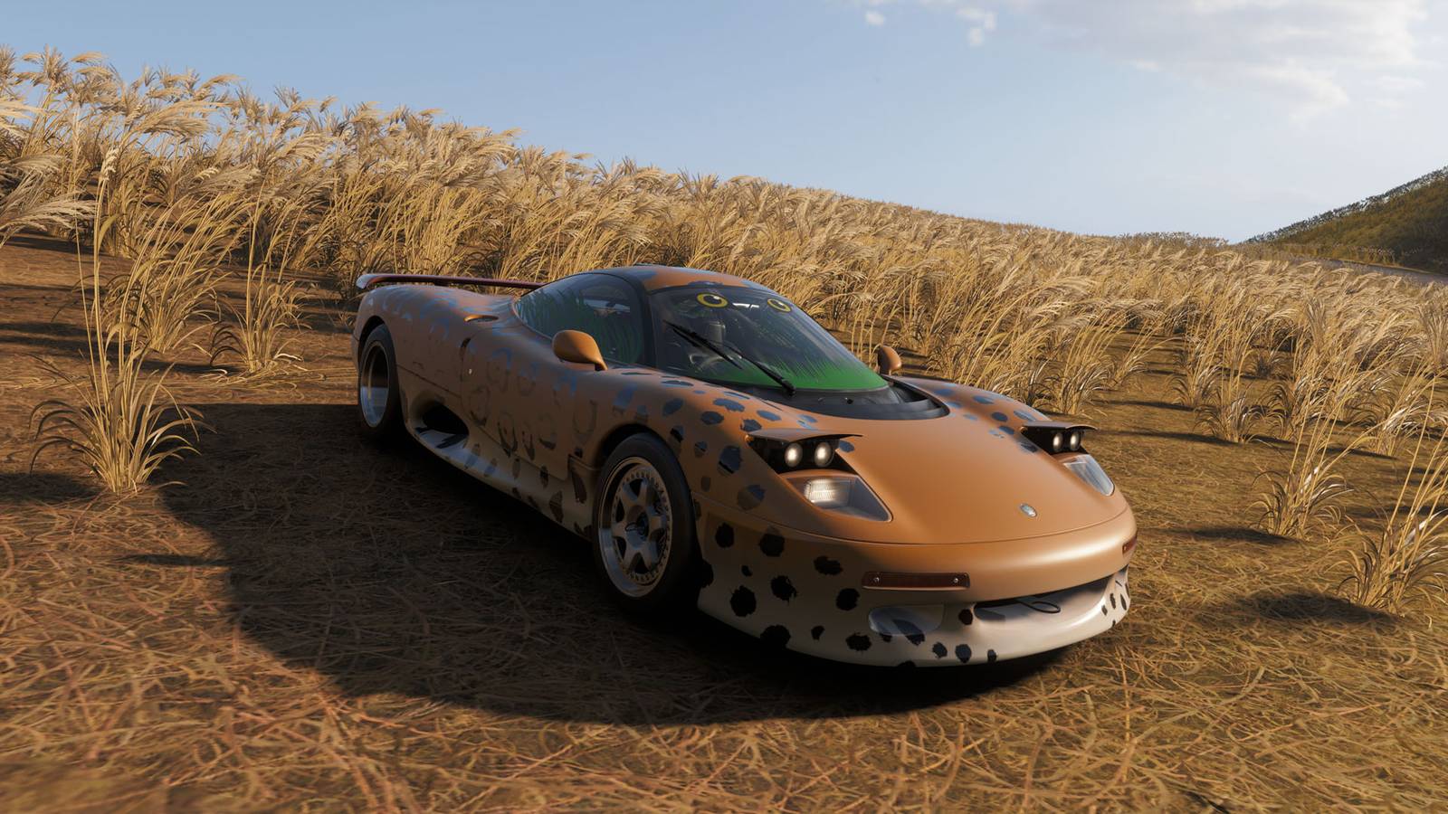 A Jaguar car with a jaguar design sitting in a wheat field in Forza Horizon 6.