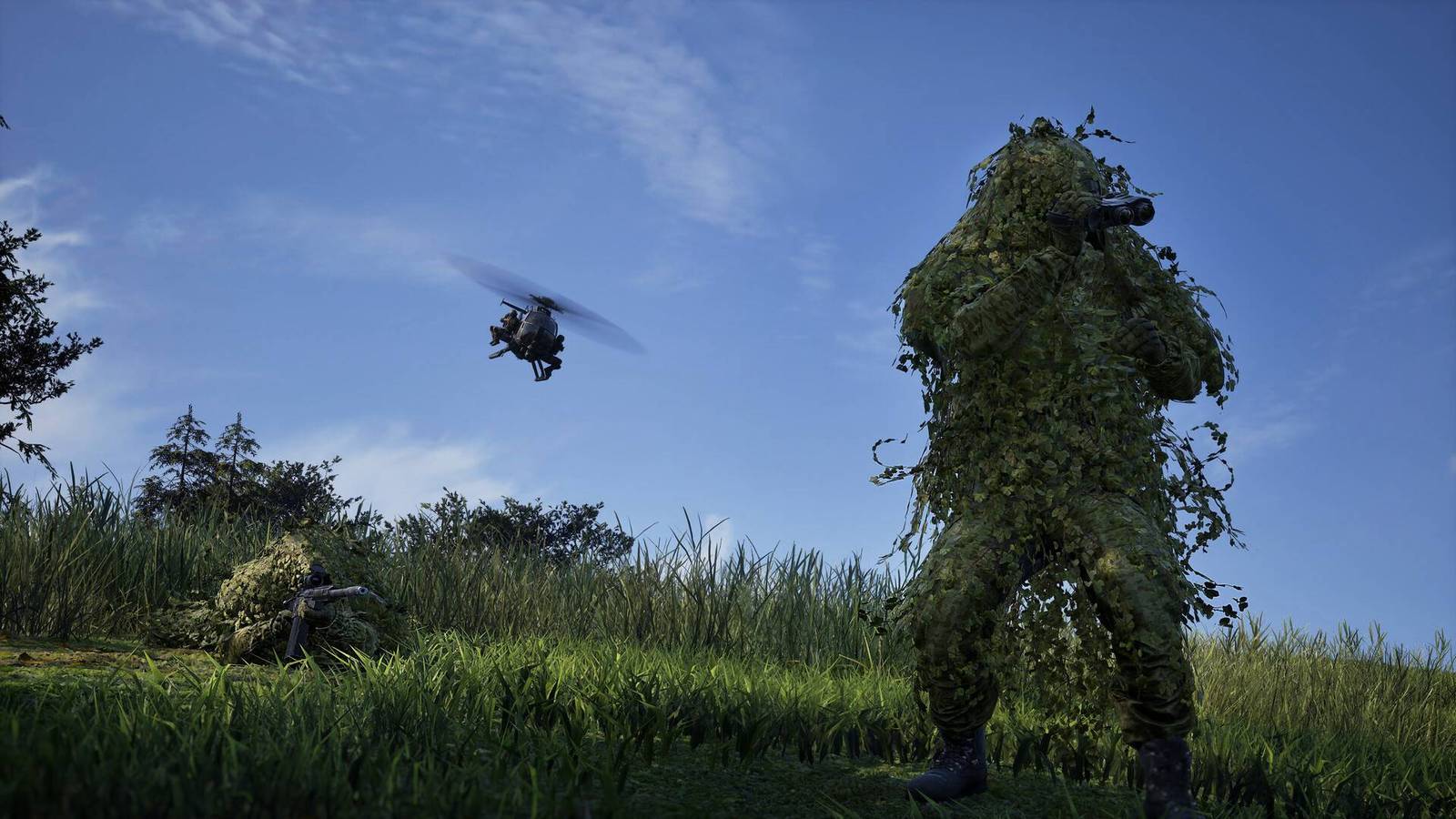 Two soldiers in ghillie suits in a field while a helicopter flies above them in Wardogs.