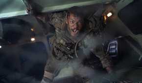 81 (Alan Ritchson) shouts inside an armored transport in a still from Netflix's War Machine