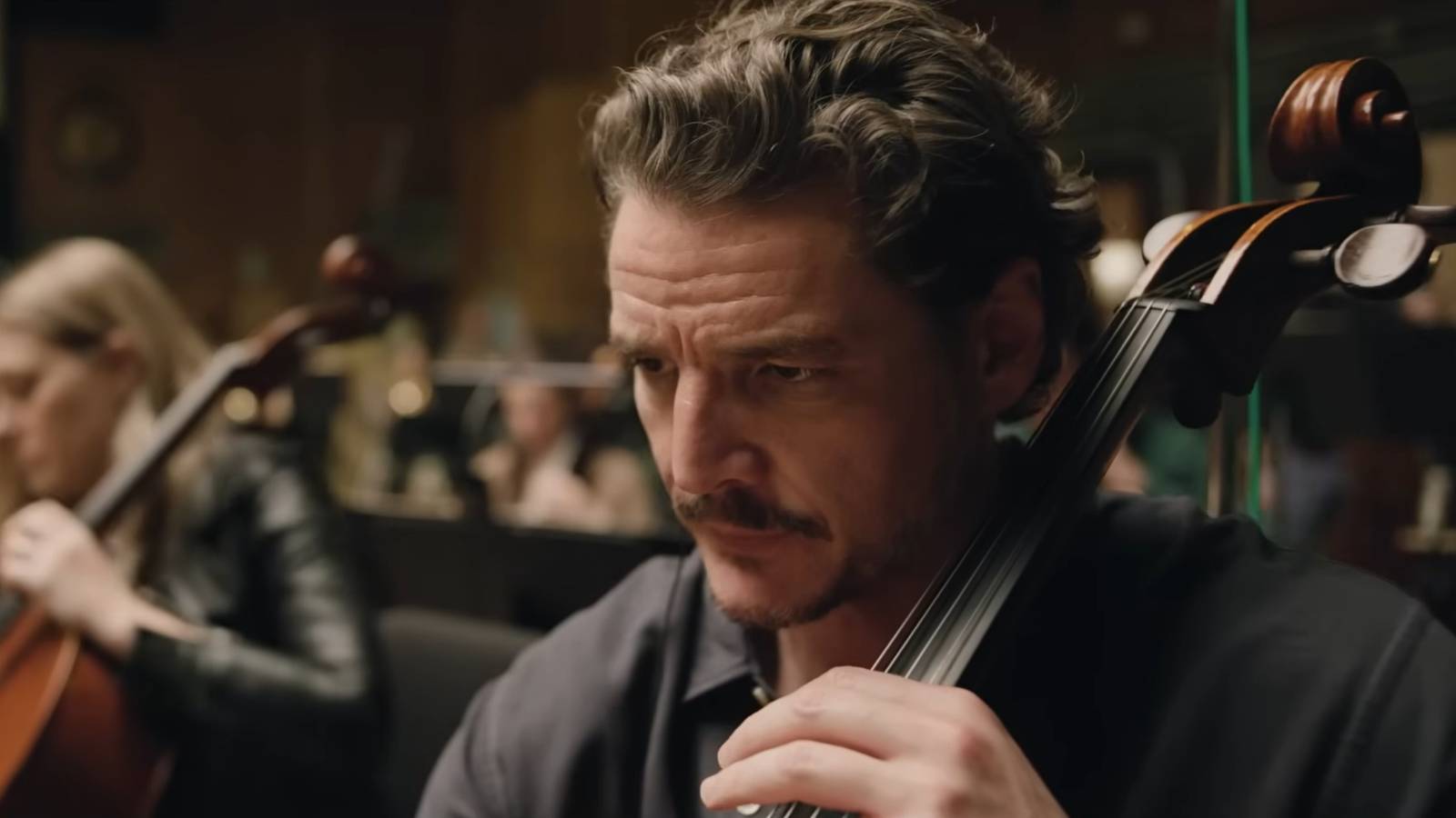 Pedro Pascal, his brow furrowed, as he plays the ciello.