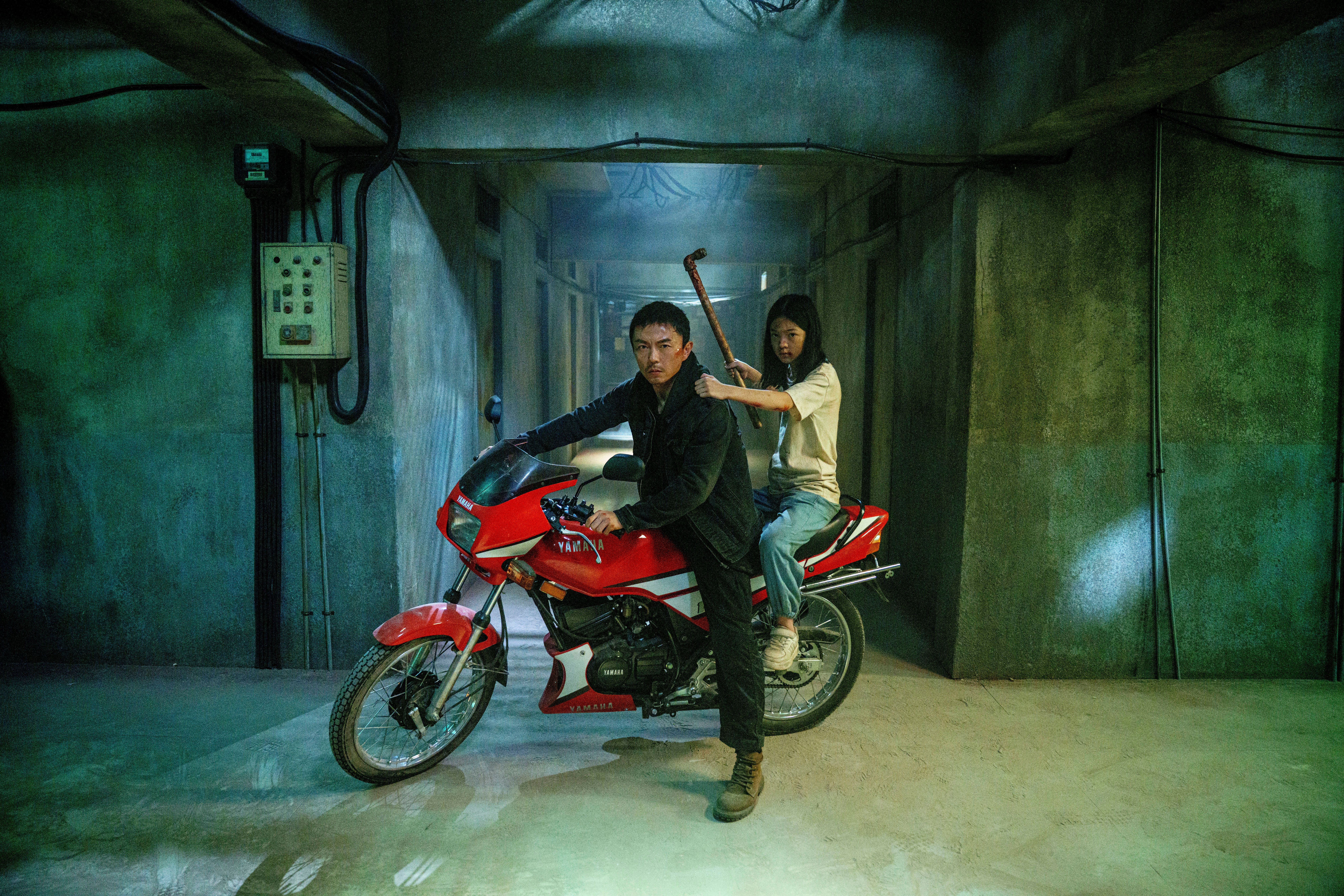 Xie Miao and his daughter on a bike in The Furious