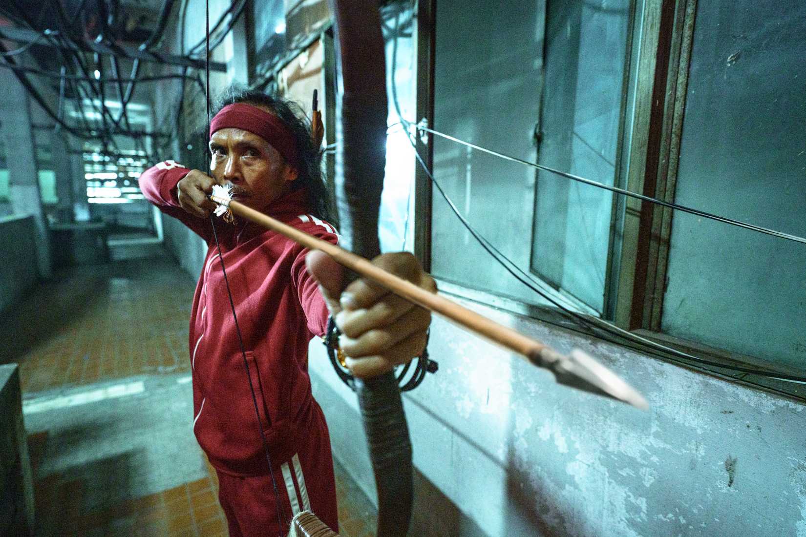 Yayan Ruhian aims a bow and arrow in The Furious