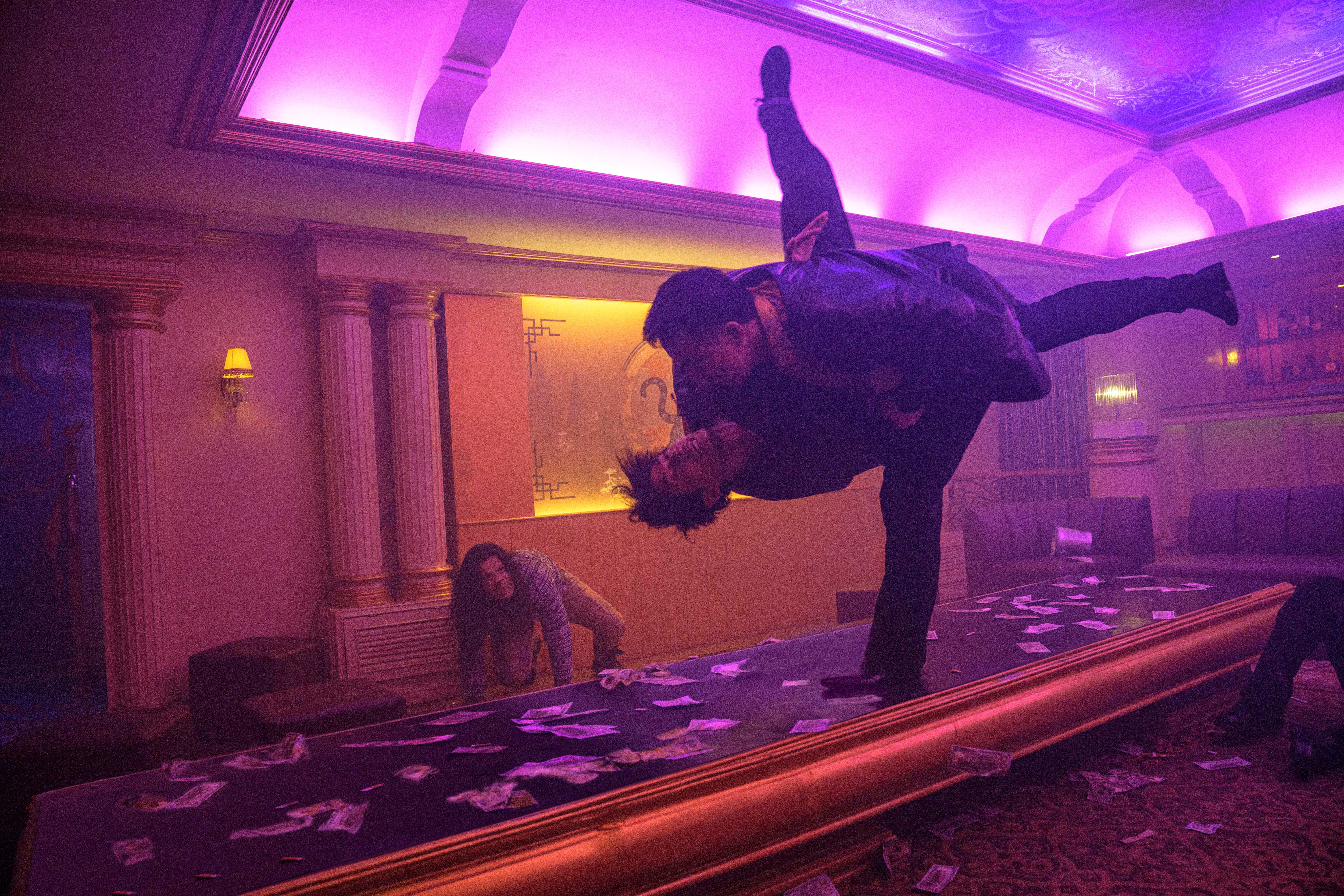 Joe Taslim throws a guy into a table in The Furious