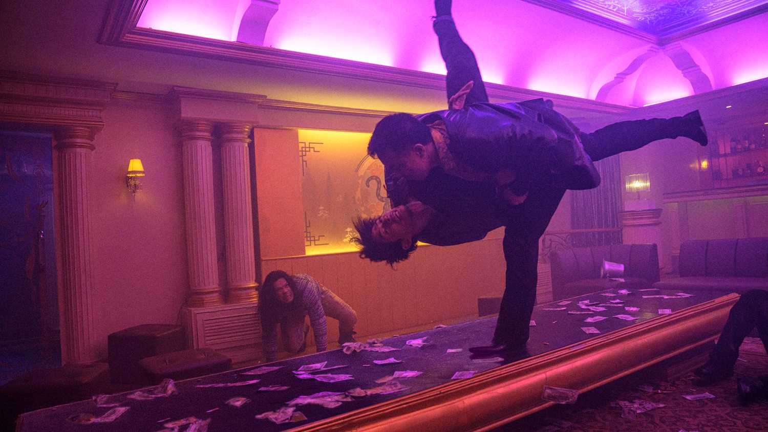 Joe Taslim throws a guy into a table in The Furious