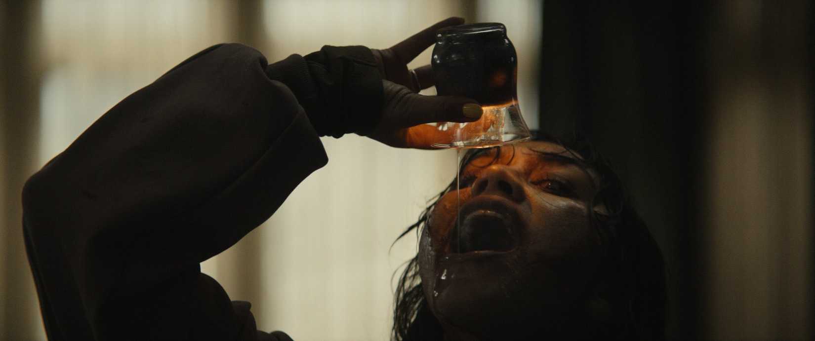 A woman drinking candle wax in Evil Dead Burn