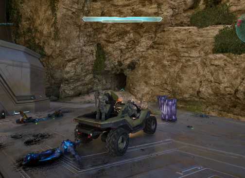 The player in Halo: Campaign Evolved driving a warthog next to the cave with the skull in.