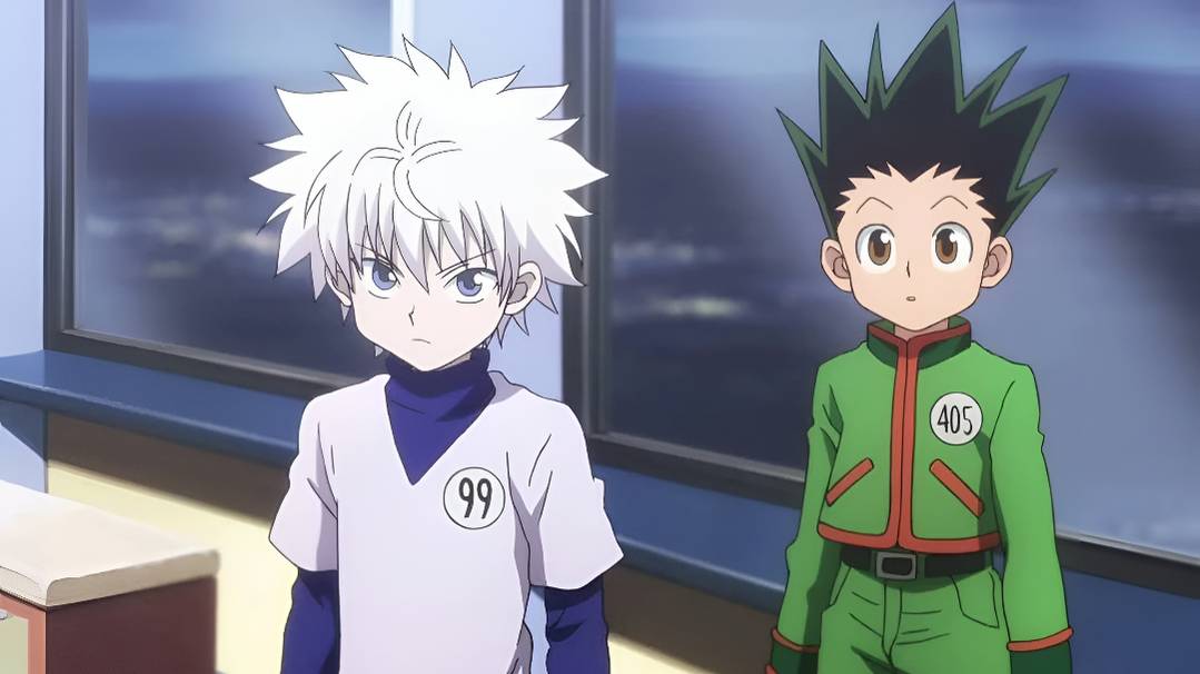 Killua and Gon stand next to each other inside a classroom in Hunter x Hunter