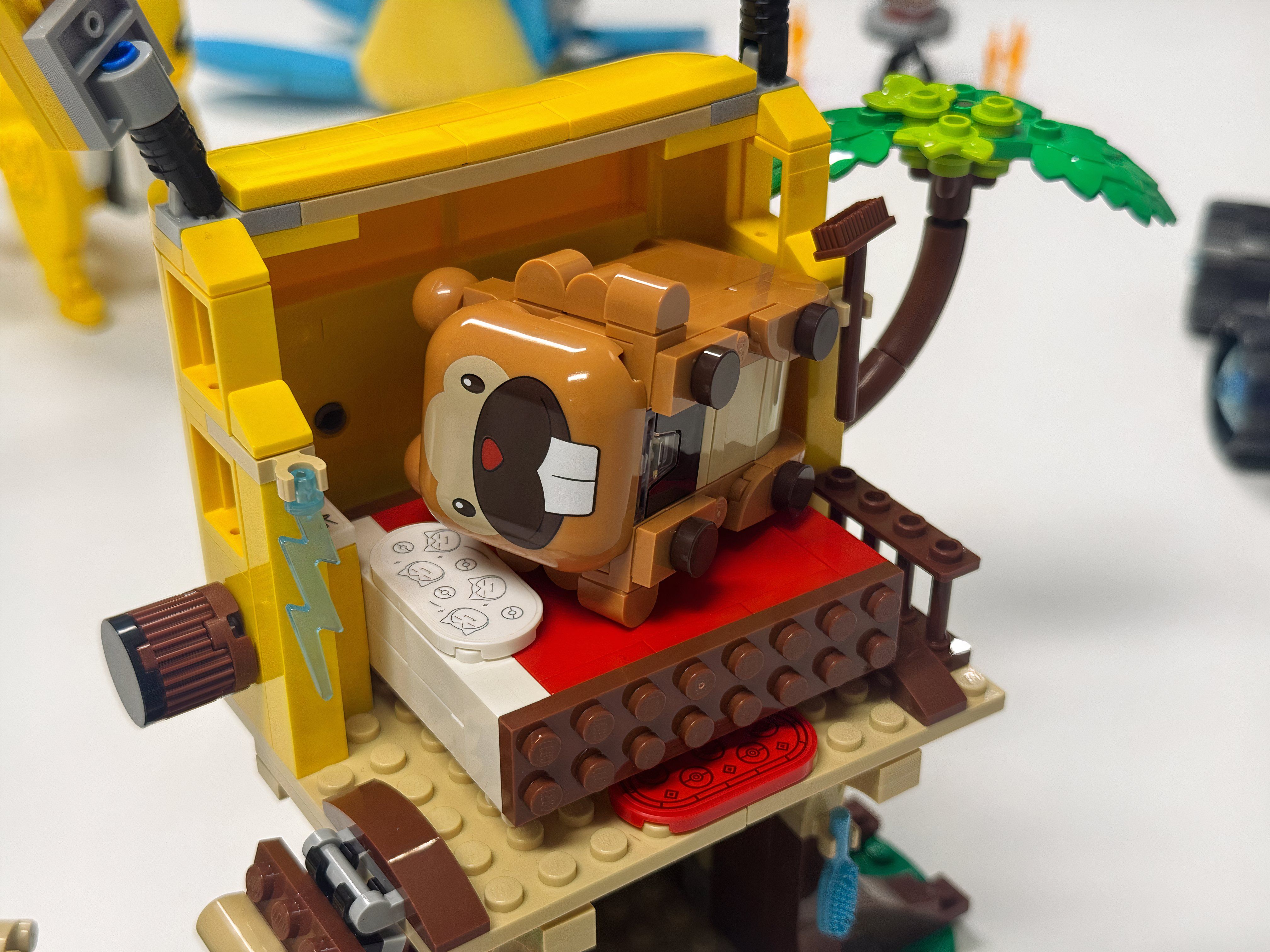 A Lego Bidoof lays in a toy bed.