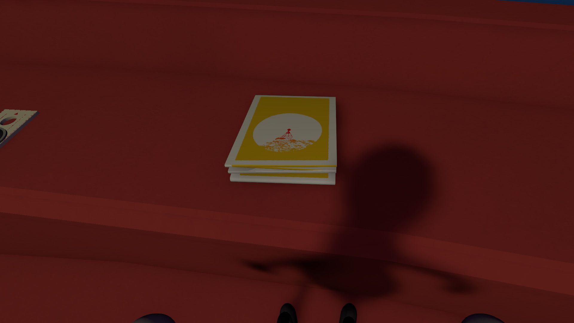 The map, a yellow pamphlet on a red desk, along with a shadow in Big Walk.