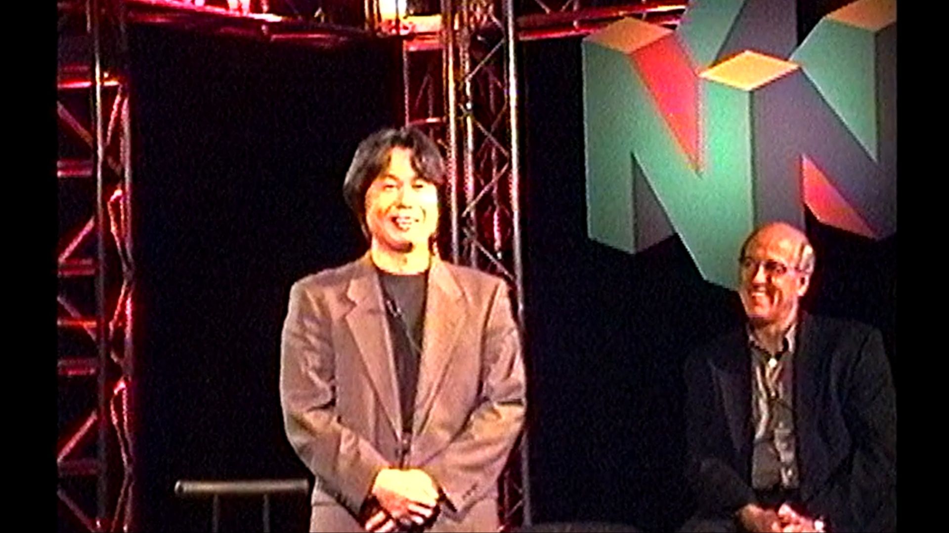 miyamoto smiling at an e3 presentation in 1998