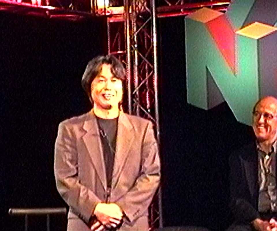 miyamoto smiling at an e3 presentation in 1998