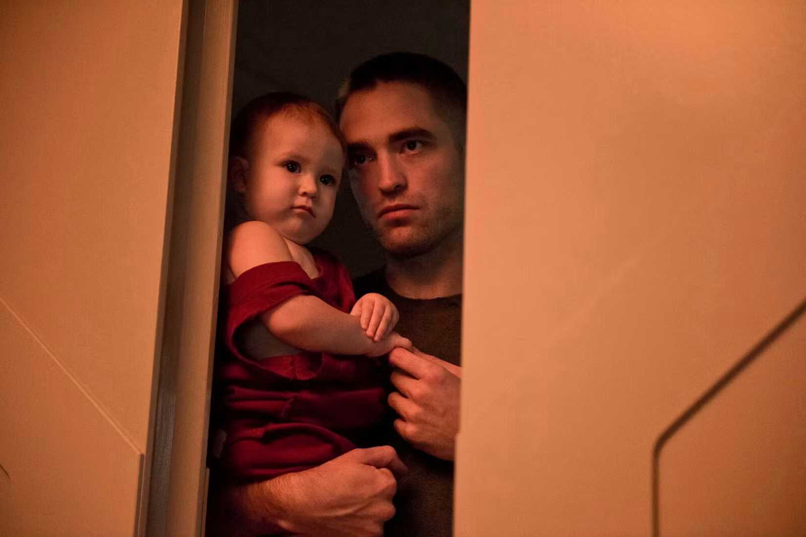 Monte holds his daughter Willow in High Life