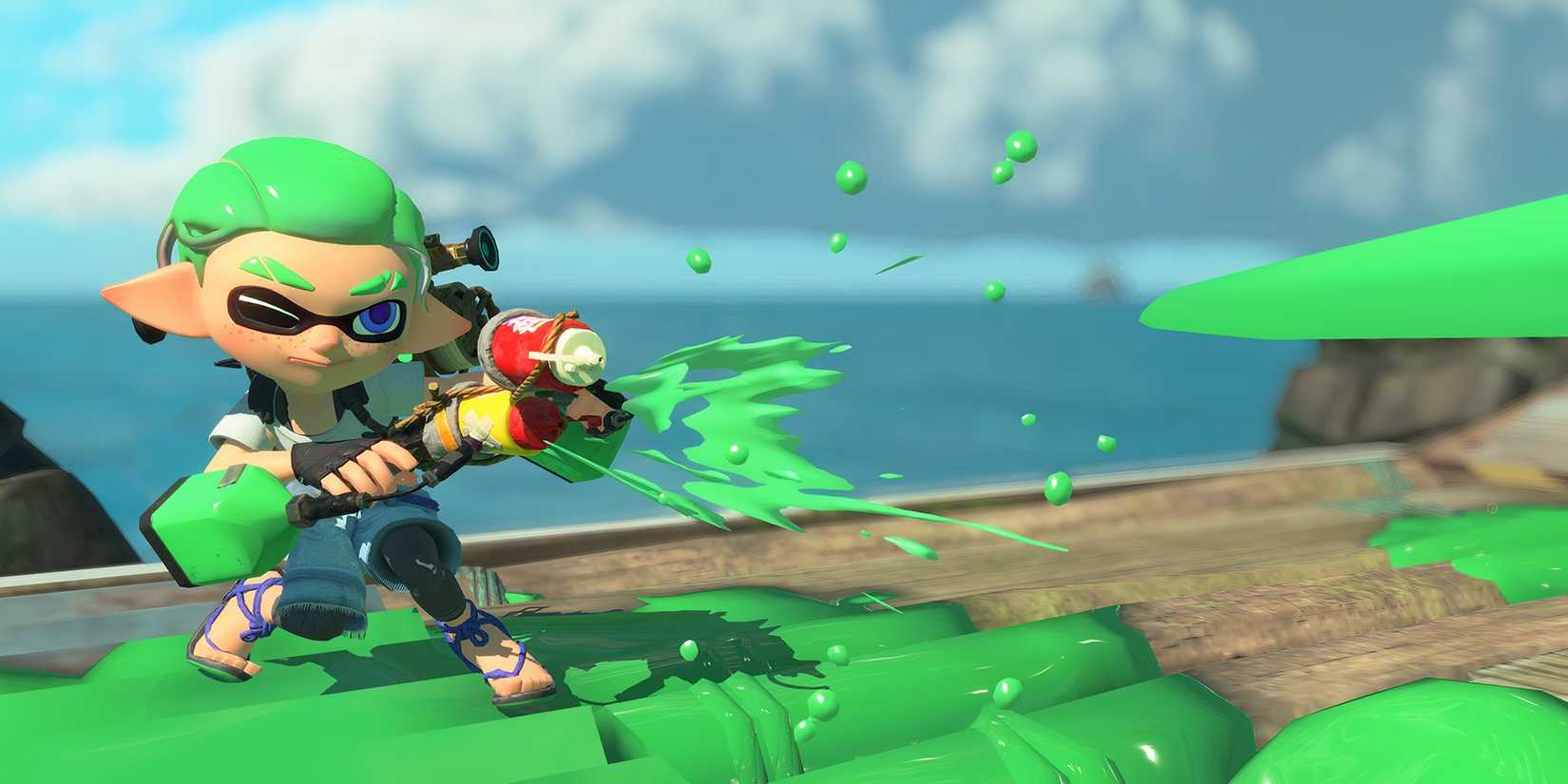 An Inkling with green hair fires a green paint weapon