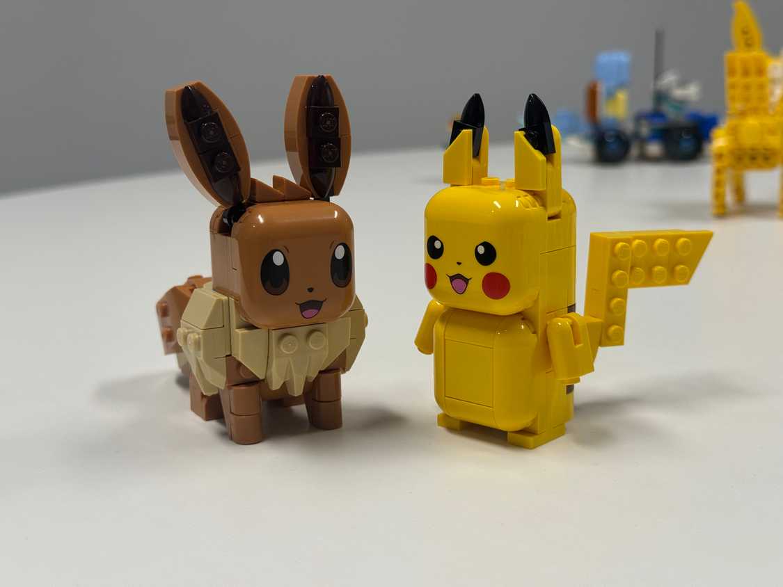 Eevee and Pikachu Smart Play toys sit next to each other.