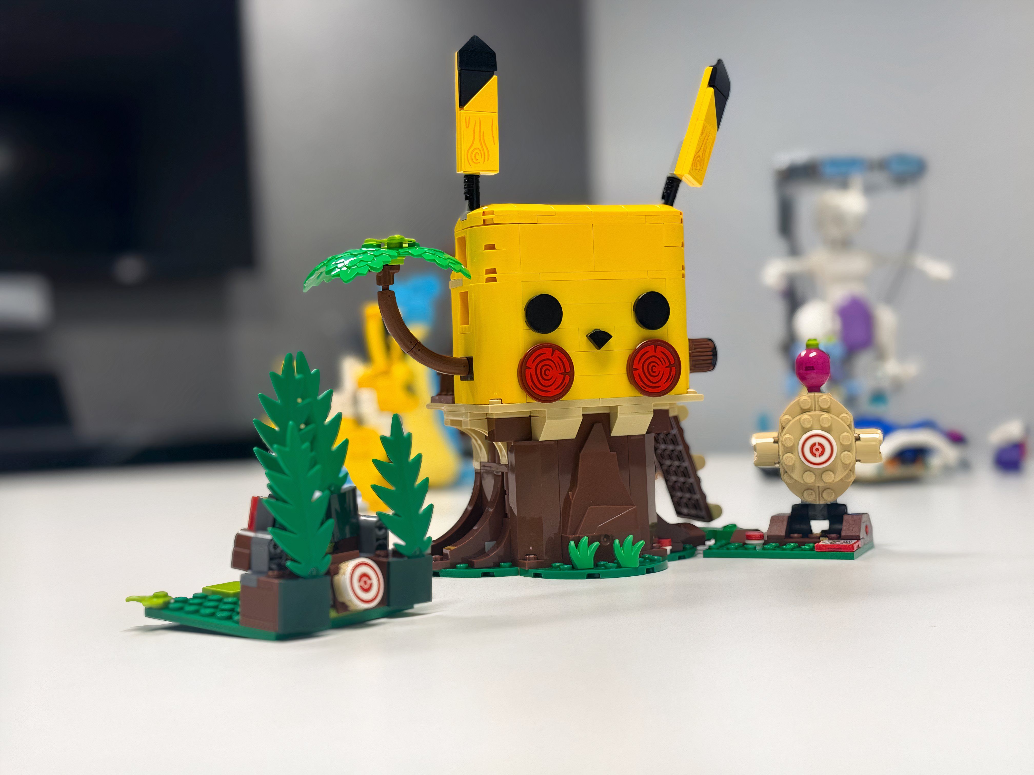 A Lego playset that looks like Pikachu sits on a table.
