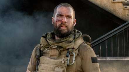 Henry Cavill with shaved head and beard in Sand Castle