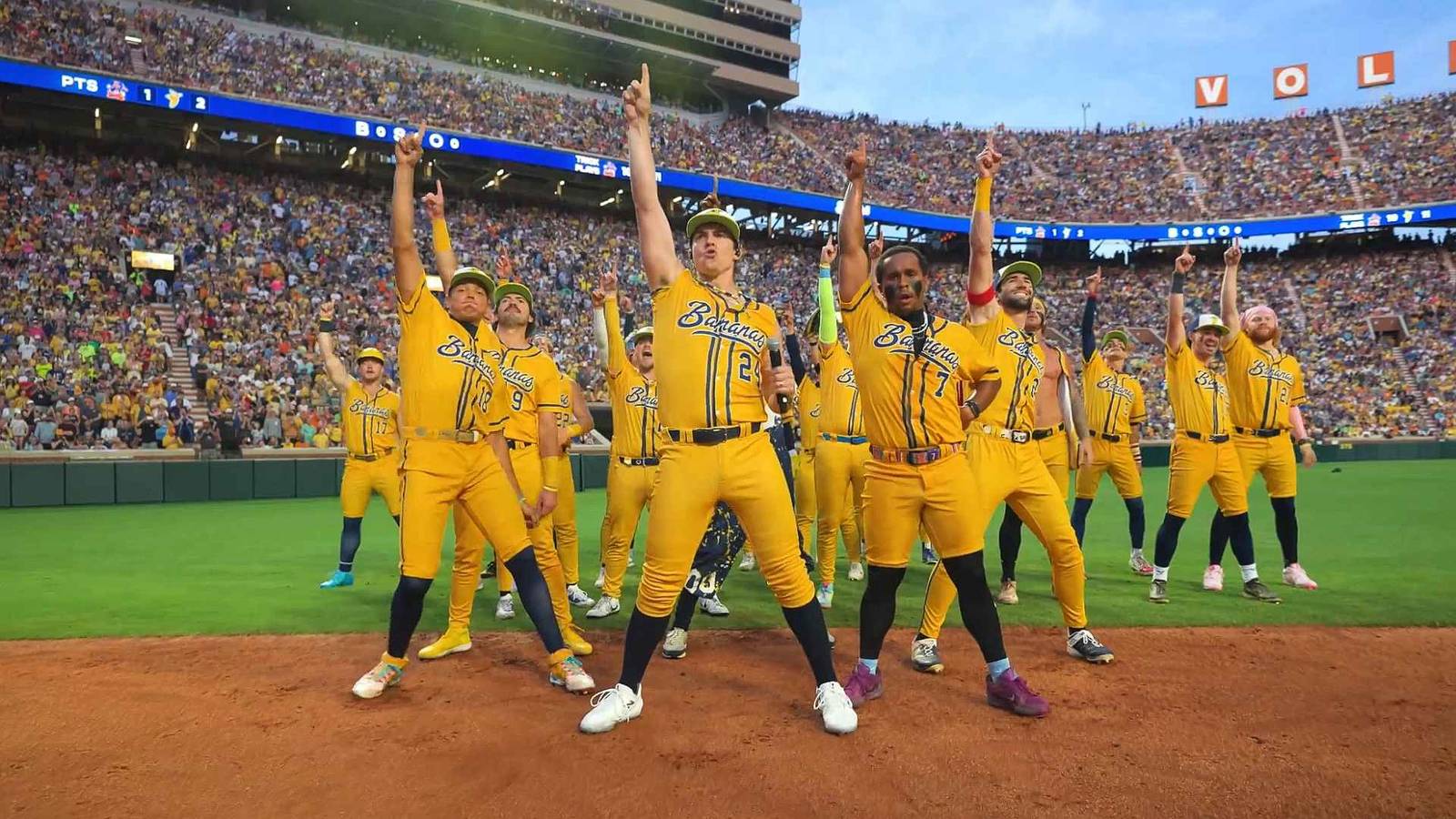 The Savannah Bananas strike a pose mid performance on a baseball field
