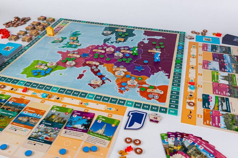 The game board and components for Abroad include a map of Europe and cards representing different places to visit