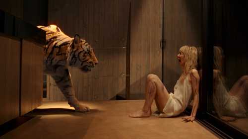 A tiger creeps up to a screaming blonde in Hot Spot