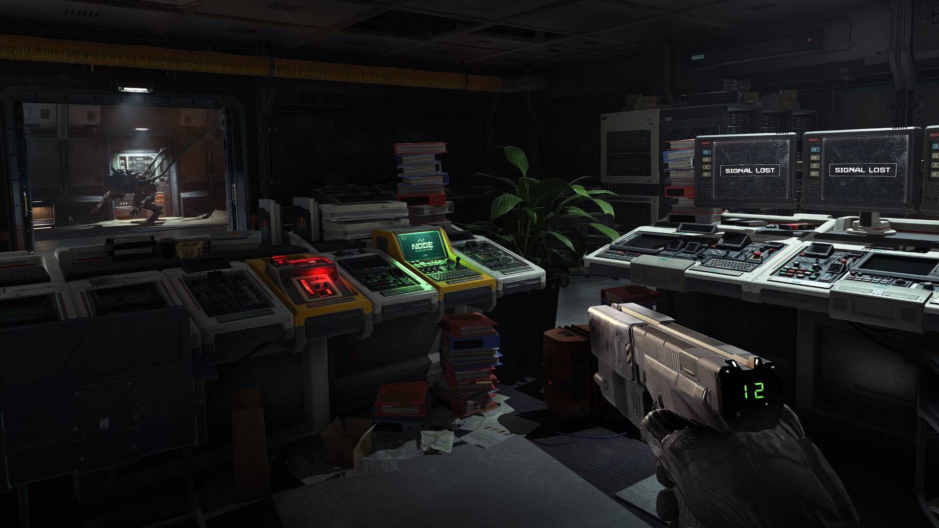 The player in Alien Deathstorm holding a pistol while an alien skulks past through the doorway.