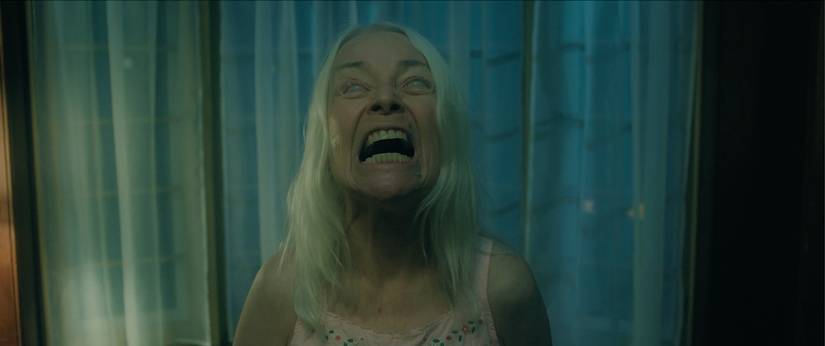 A woman with white hair screaming in Bury the Devil