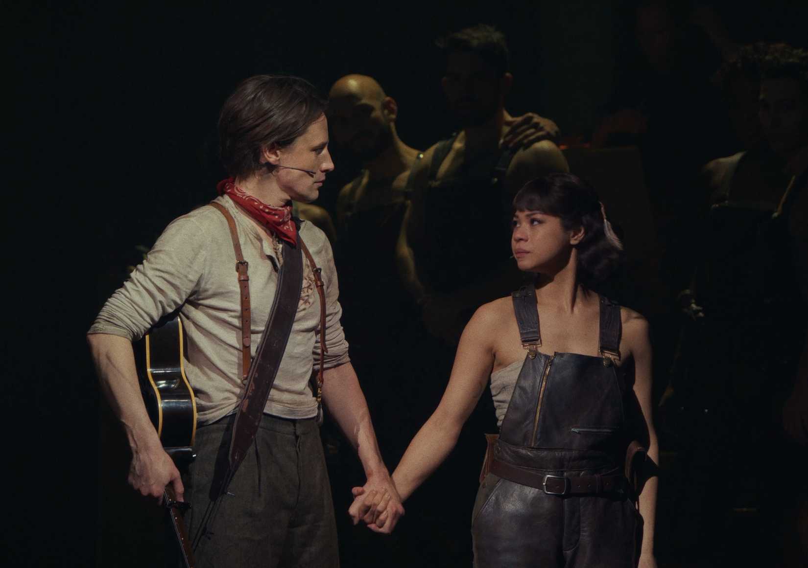 A man and a woman holding hands in Hadestown the Musical