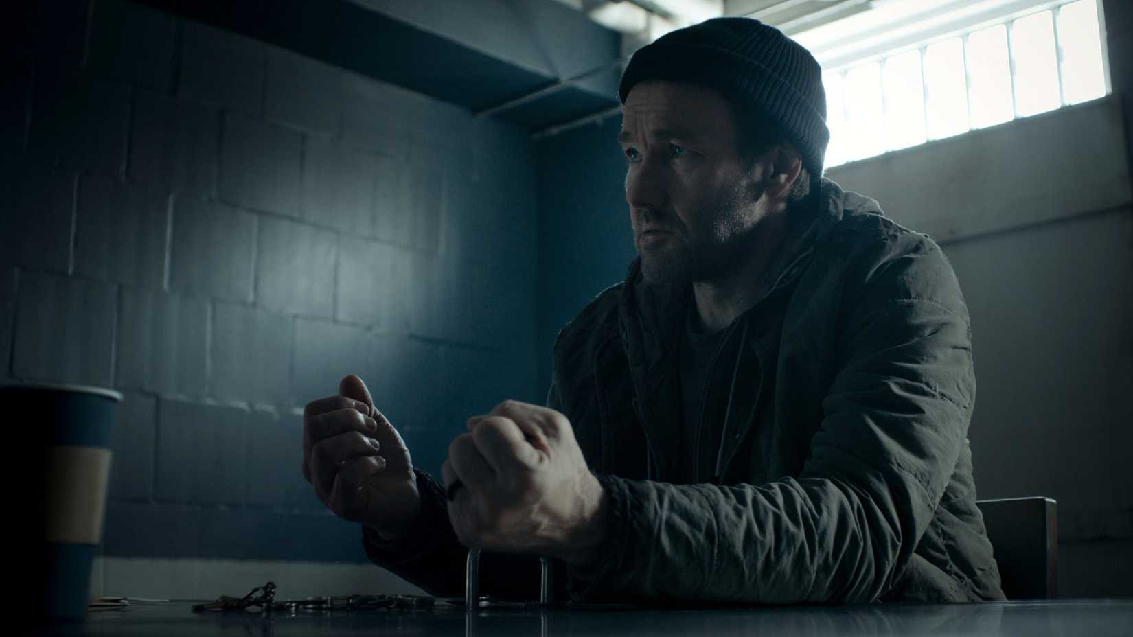 Jason Dessen (Joel Edgerton) holds out his wrists which are handcuffed to a table in Dark Matter season 2