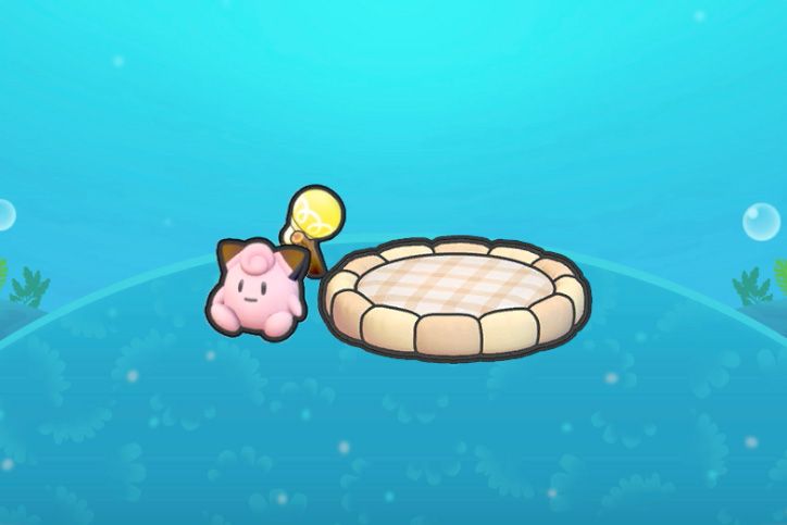 A round bed near a light with a Clefairy doll in Pokopia