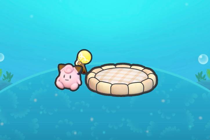 A round bed near a light with a Clefairy doll in Pokopia