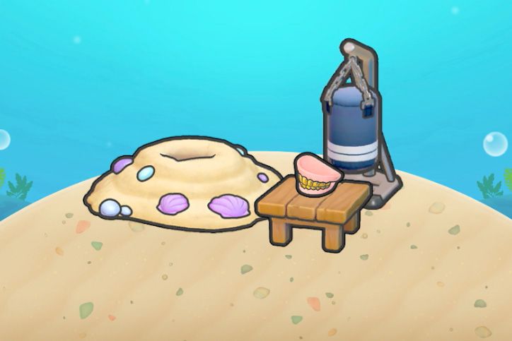 A sand mound next to a punching bag and a set of gold teeth on a table in Pokopia