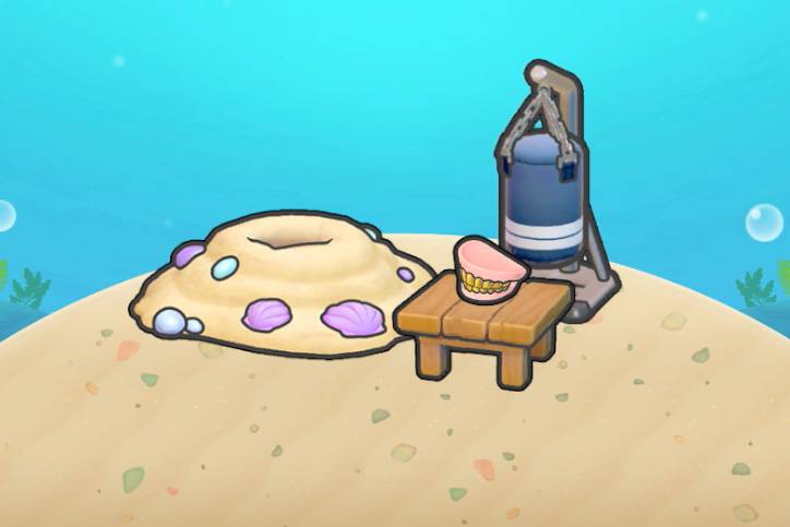 A sand mound next to a punching bag and a set of gold teeth on a table in Pokopia