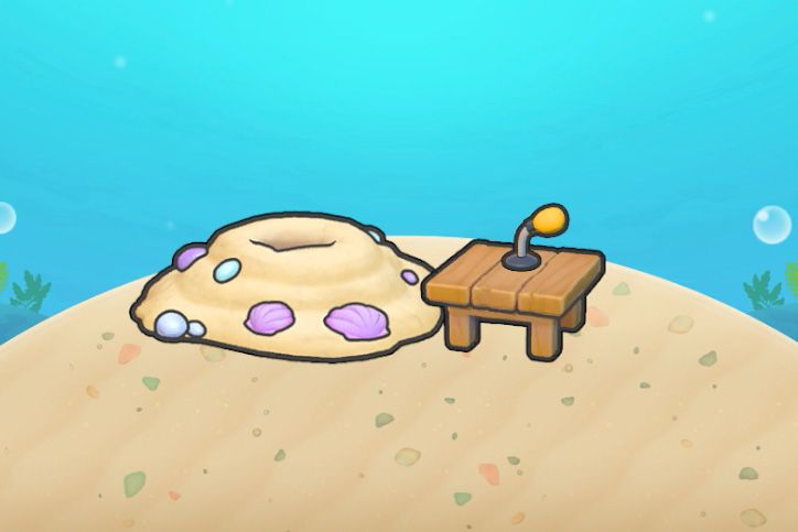 A pile of sand next to a table with a small microphone on it in Pokopia